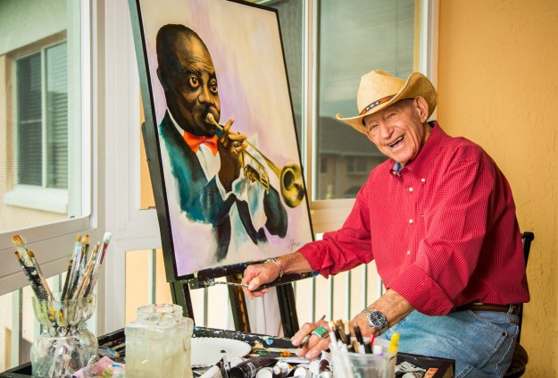 portrait-photography-of-senior-man-posed-with-painting-and-paint-brushes