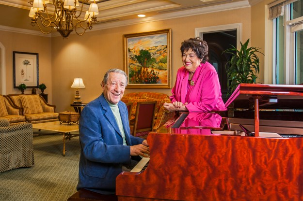 portrait-photography-of-senior-man-playing-piano-while-senior-woman-looks-on