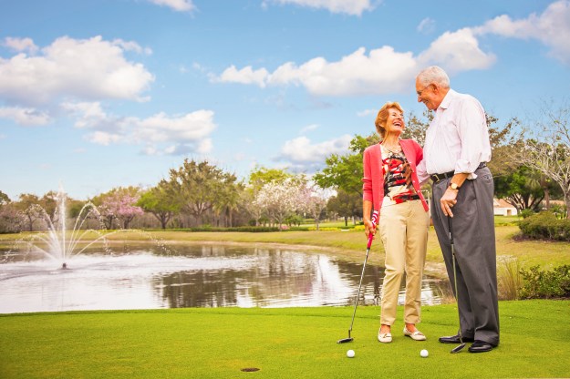 lifestyle-photography-of-senior-couple-golfing-in-naples-florida-with-fountain-in-background