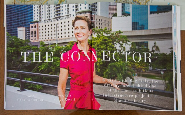 portrait photo of meg daly in pink dress standing in front of brickell skyline