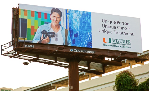 Uhealth Sylvester Advertising billboard featuring portrait of photographer in wynwood holding camera