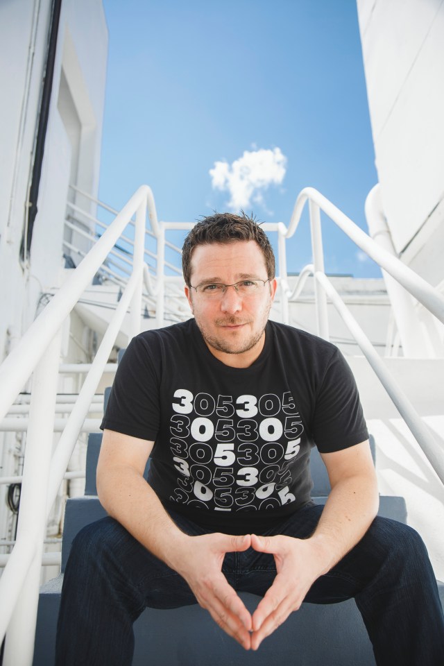 portrait photography of Billy Corben seated on staircase outside