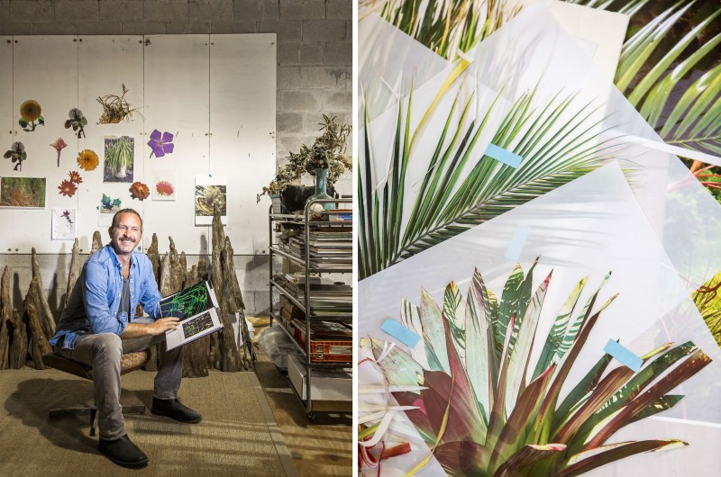 Artist, Phillip Estlund, looking through a book in his wood-working studio