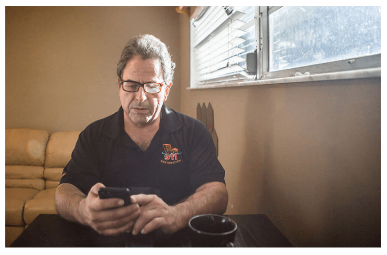 Luis Garcia looking at phone