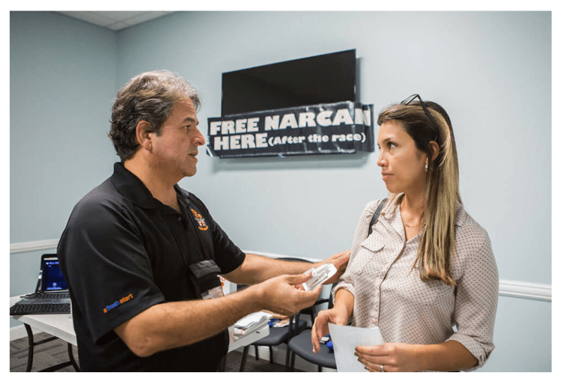 Luis Garcia handing out Narcan nasal spray at his class