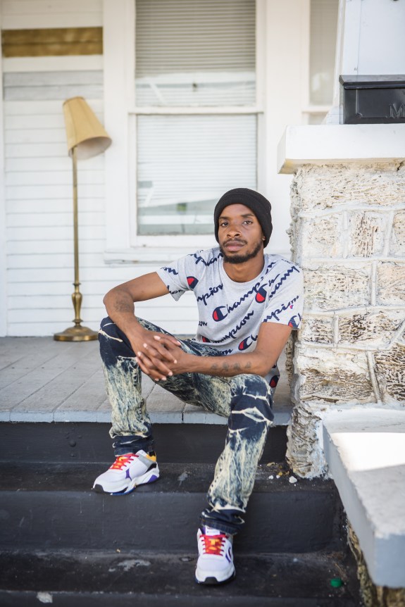 portrait photography of Hakeem Drane, sitting outside on steps