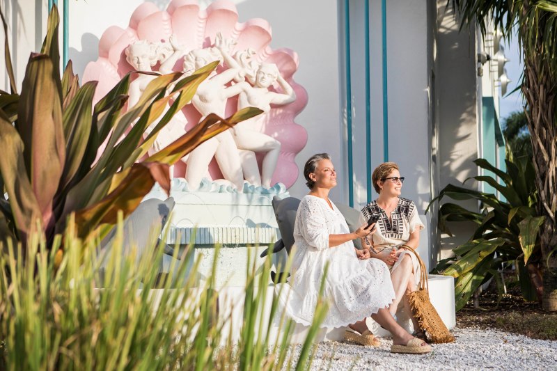 lifestyle photography of two ladies sitting in front of the fountain at the vagabond motel